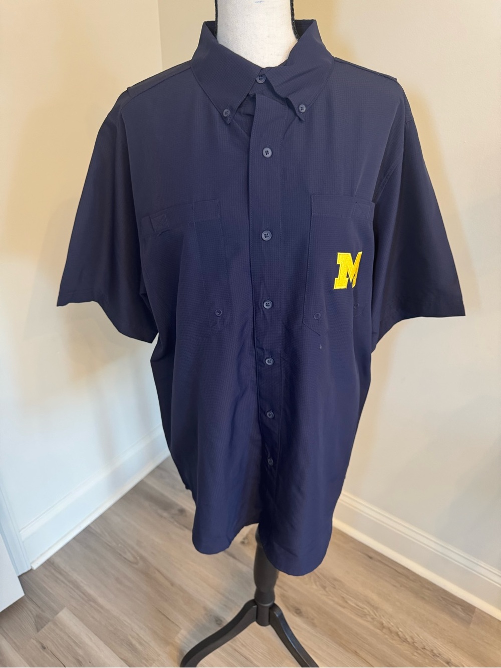 Pro Edge navy blue short sleeve shirt featuring the Michigan Wolverines logo